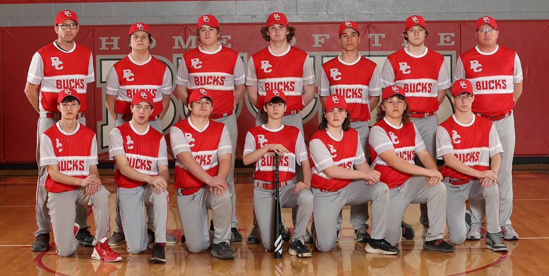 A group of young boys in red and white uniforms posing for a photo

Description automatically generated