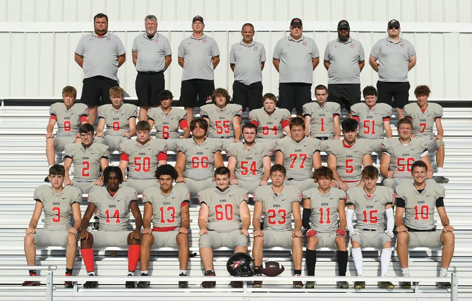 A group of football players posing for a photo

Description automatically generated