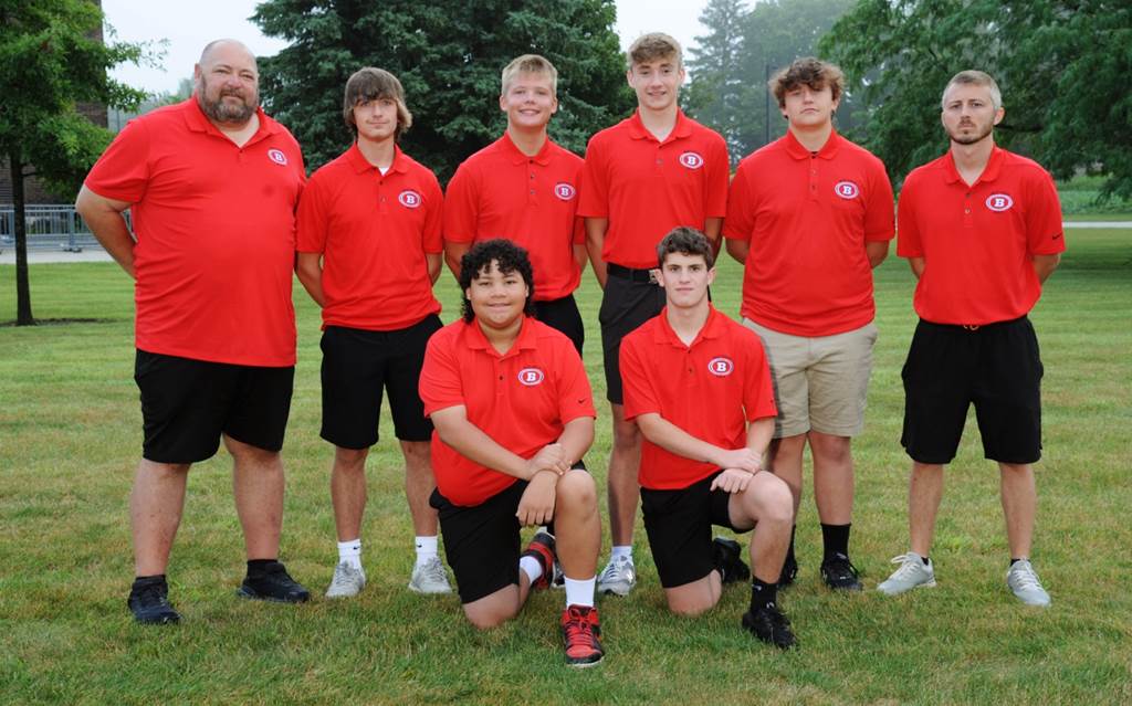 A group of men in red shirts

Description automatically generated