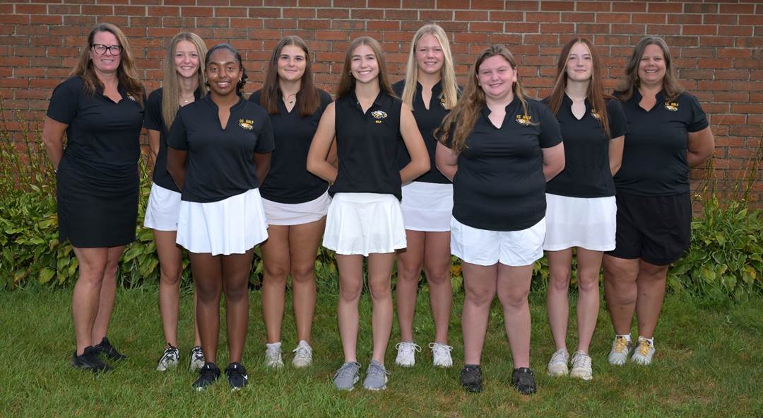 A group of women in black shirts and white skirts

Description automatically generated