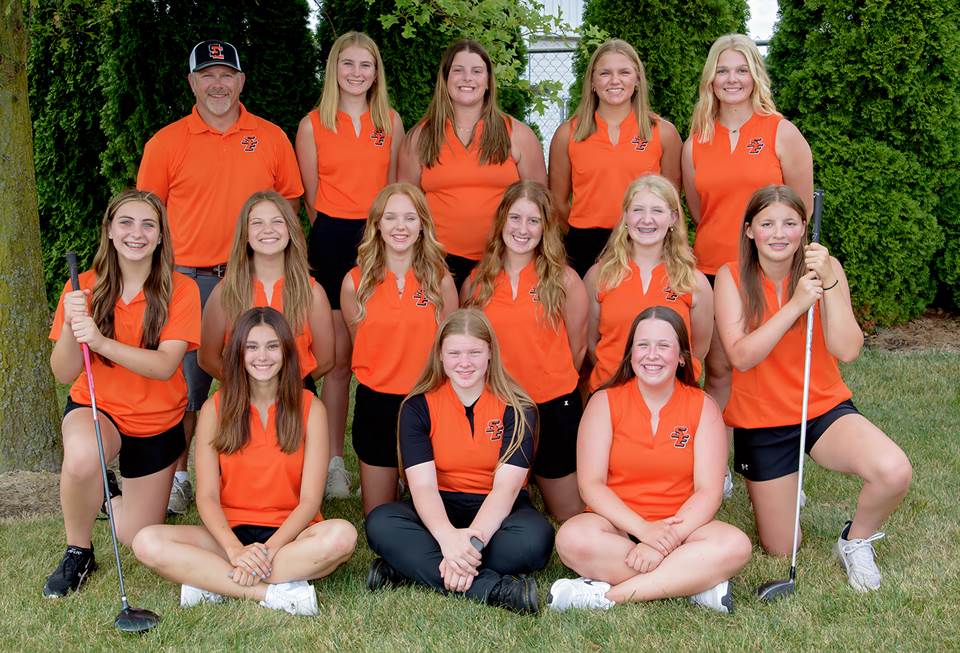 A group of women in orange shirts

Description automatically generated